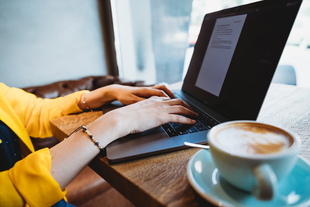 a digital nomad works and enjoys coffee while traveling