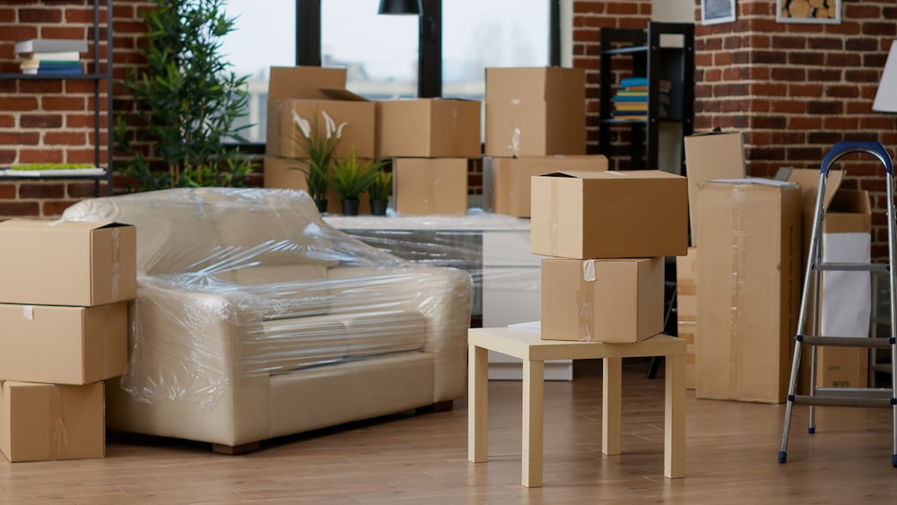 packed up living room with boxes and furniture