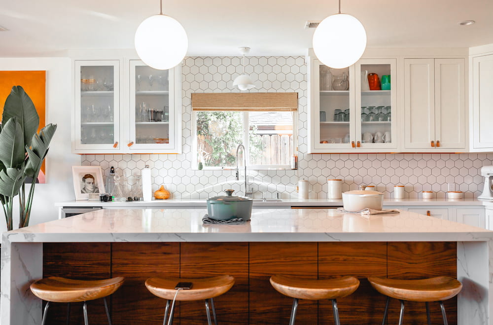 decluttered and organized white kitchen with wood barstools