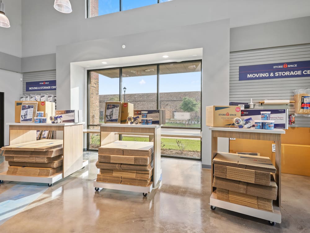 stacked flat boxes and packing supplies in a self-storage facility office